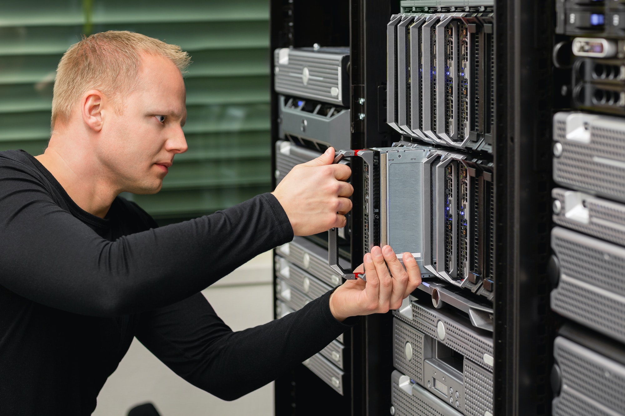 Male Technical Consultant Replacing Blade Server In SAN At Datacenter